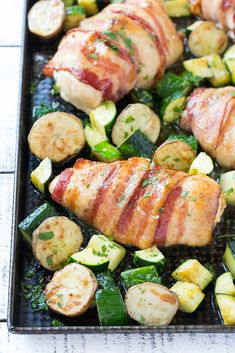 chicken, zucchini and potatoes on a baking sheet