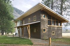 three pictures of a house in the woods with windows and wood sidings on each side