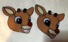 two deer head shaped mirrors sitting on top of a white towel next to each other