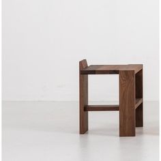 a small wooden table sitting on top of a white floor