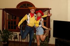 a man and woman dressed up in cowboy outfits posing for a photo together with their arms around each other