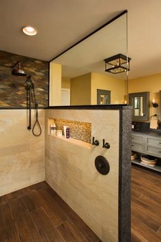 a bathroom with wood flooring and tile on the walls, along with a walk in shower