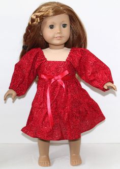 the doll is wearing a red dress