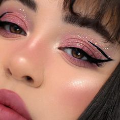 a woman with pink makeup and glitter on her eyes