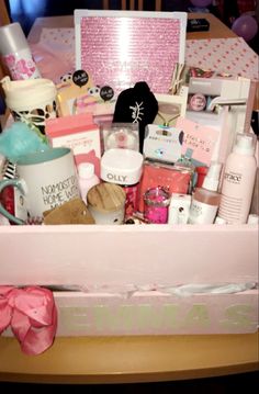 a pink box filled with lots of different types of beauty and personal care items on a table