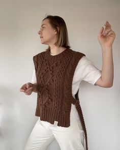 Handmade cable knit sweater vest for women is carefully made from soft alpaca wool yarn, is available in multiple colors and sizes. Sleeveless jumper is decorated with cables, bubles and braids, has slightly longer back. Its side ties with metal buckles, which looks extra sophistication. Warm, cozy, and dreamy. Natural tones, clean cuts, amazing details and high-quality fabric make you look and feel your best!   Feel free to contact me for custom vest orders. Ethically hand knitted in Lithuania. Chunky Sweater Vest, Womens Sweater Vests, Sleeveless Sweaters, Spring Knitwear, Cable Knit Sweater Vest, Alpaca Wool Sweater, Vest For Women, Sleeveless Jumper, Knit Sweater Vest