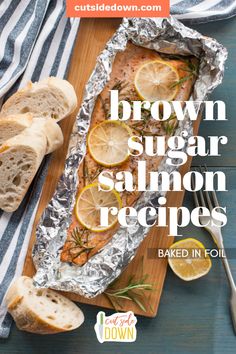 brown sugar salmon with lemons and herbs on a cutting board next to sliced bread