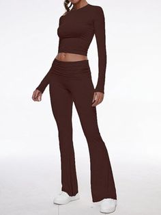 Step out in style with our contemporary two-piece set, combining comfort and fashion in one. The ensemble features a body-hugging crop top with long sleeves and matching low-rise pants with a gentle flare. Each piece is crafted from high-quality modal fabric that's both soft to the touch and elastic for durability. Features: Quality Fabric: The set is made from premium modal, known for its softness and elasticity, ensuring both comfort and longevity. Chic Design: With a round neckline and croppe Solid Fitted Long Sleeve Sets, Solid Color Fitted Long Sleeve Sets, Fitted Wide Leg Solid Color Sets, Fitted Solid Color Wide Leg Sets, Solid Color Fitted Wide Leg Sets, Trendy Stretch Wide Leg Sets, Stretch Cropped Loungewear Set, Fall Wide Leg Stretch Sets, Fall Stretch Wide Leg Sets