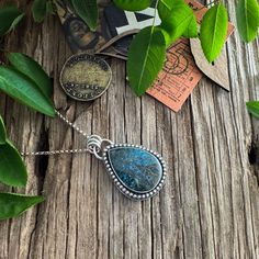 "A stunning Shattuckite stone with shades of azure to a dark, deep blue is the focal point for this pendant. The colors are amazing, and the pattern almost seems like branches and roots of a tree!  I've set this beautiful stone within a beaded wire border, and the back is patterned with an paisley pattern for a lovely, unique showpiece. Shattuckite is believed to be a stone of intuition, mediumship, and psychic abilities, offering clarity of the mind, heart, and throat, and creating a connection Blue Turquoise Necklace With Large Teardrop Stone, Unique Blue Teardrop Turquoise Necklace, Blue Chrysocolla Necklace With Large Stone, Artisan Blue Turquoise Teardrop Pendant Necklace, Blue Turquoise Necklace With Large Chrysocolla Pendant, Blue Turquoise Chrysocolla Necklace With Large Pendant, Turquoise Necklace With Large Chrysocolla Pendant, Blue Chrysocolla Pendant Necklace, Blue Teardrop Necklace With Large Stone