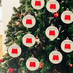 a christmas tree decorated with red and white ornaments, hanging from it's sides