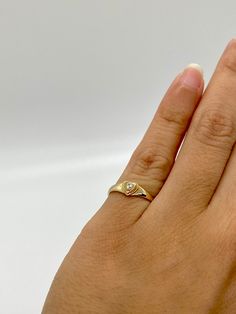 This cute 14K gold heart signet ring with a center stone is the perfect size for a baby, child, or pinky ring for women. The center stone is a simulated pink or white diamond (Cubic Zirconia). The ring is made of 100% 14K gold. It's a beautiful ring for a little girl or a gorgeous pinky ring. Ring pictured on a small child's hand and woman's 2 1/2 pinky finger * Stamped 14K gold * High Quality Cubic Zirconia Stone * Small sized Ring ▬ All jewelry pieces are sent in a gift box ▬ Our shipping and Heart Cut Signet Ring For Anniversary On Valentine's Day, Heart Cut Signet Ring For Valentine's Day, Gold Heart Rings With Bezel Setting, Gold Heart Cut Ring With Bezel Setting, Valentine's Day Heart Cut Signet Promise Ring, Valentine's Day Heart Cut Signet Ring, Gold Heart Ring With Bezel Setting, Yellow Gold Heart Birthstone Promise Ring, Heart-shaped Bezel Setting Ring For Anniversary