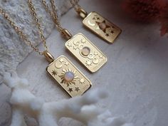 We're so excited to introduce my new line of high quality, anti-tarnish, waterproof jewelry. Thanks to our special plating technique, this celestial beauty is built to last, both pendant and chain are anti tarnish and waterproof. Crafted with hypoallergenic 18k gold stainless steel, it's lead and nickel free and safe and comfortable for sensitive skin. Your choice of pendants feature three of my favorite Major Arcana cards and a sweet little faux opal cabochon for an added touch of mystery. Choo Silver Celestial Jewelry Tarnish Resistant, Celestial Silver Jewelry Tarnish Resistant, Celestial Style Silver Tarnish-resistant Jewelry, Celestial Gold Jewelry With Rectangular Pendant, Gold Celestial Jewelry With Rectangular Pendant, Celestial Style Tarnish Resistant Necklace As Gift, Celestial Tarnish-resistant Necklace As Gift, Celestial Style Tarnish-resistant Necklace For Gifts, Celestial Rectangular Pendant Jewelry Gift