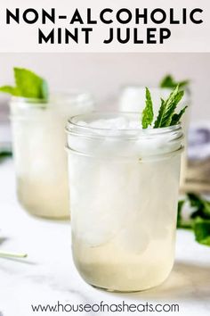 two mason jars filled with ice and mint on top of a white countertop, the text reads non - alcoholic mint julep