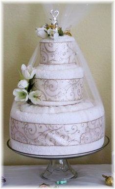 three tiered wedding cake with white flowers on top