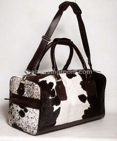 Make a statement on your travels with our stunning black and white cowhide weekender bag, a must-have accessory for western events or southern-themed getaways. - Free shipping on all our cowhide duffle bags. - Dimensions: 20 Inches x 11 Inches x 10 Inches. - Detachable real leather shoulder straps and handles. - inside cloth lining with 1 zipper pockets and 2 open pockets. - 2 exterior open pockets. - real leather base. - It takes approx seven business days to complete each cowhide duffle bag. - White Leather Duffle Bag For Travel, White Leather Travel Duffle Bag, White Leather Travel Bag, White Leather Rectangular Weekender Bag, Large Capacity White Leather Travel Bag, Rectangular Cow Print Travel Bag, Large Capacity White Leather Weekender Bag, White Leather Weekender Bag With Luggage Sleeve, Travel Duffel Bag