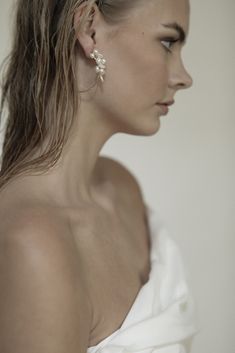 An abstract take on the classic hoop— freshwater pearls cluster along the top of a gold-plated hoop to create a full-bodied feel without too much drama. #bridal #antibride #modern #bride #statement #earrings #gown #weddinginspiration #pinterestinspiration #weddingday #weddingstyle #bridalinspo #modernbride #romanticbridal Pearl White Pearl Bridal Accessories, Elegant Bridal Accessories For Bridesmaids, Delicate Pearl Drop Bridal Accessories For Wedding, Pearl White Bridal Accessories With Pearl Drop For Wedding, Pearl White Wedding Accessories With Pearl Drop, Vivienne Westwood Jewellery, Contemporary Bridal, Modern Wedding Inspiration, Mens Items