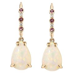 Embrace the enchanting play of colors with this exquisite opal Drop Earrings, these earrings adorned with pink tourmaline. these earrings are made in elegant 18Karat Rose gold. Its iridescent glow and delicate simplicity make it a timeless accessory, perfect for enhancing any ensemble. Opal Drop Earrings in 18Karat Yellow Gold with Pink Tourmaline & Diamond. Opal: 4.44 carat, 12X8mm size, pear shape. Pink Tourmaline: 0.09 carat, 1.50mm size, round Shape. White Diamond: 0.02 carat, 1.15mm size, r Pink Opal Earrings, Morganite Earrings, Moonstone Drop Earrings, Opal Drop Earrings, Pink Morganite, Tourmaline Stone, Naha, Amethyst Earrings, Opal Earrings