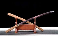 two wooden swords sitting on top of a table