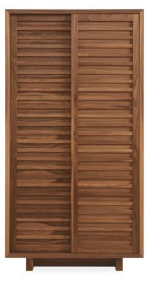 a wooden cabinet with shutters on the front and bottom, in an angled position