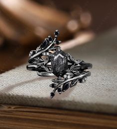 a black diamond ring sitting on top of a wooden table