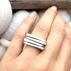 Minimalist Geometric Simple Stacking Ring. Hand carved minimalist asymmetrical bar ring. Perfect alone or stacked in multiples. Carved out of wax and cast in an intentionally organic, rounded, raw style to preserve the handmade design. Feels great on and is definitely eye catching stacked in alternating directions.  Cast in silver and white brass (hypoallergenic; lead and nickel free). Currently only available in size 6 You choose how many you want, the more you stack the better the deal :) Stacked Minimalist Midi Rings, Minimalist Stackable Rings, Modern Stacked Jewelry, Modern Handmade Stackable Rings With Open Band, Modern Handmade Stackable Rings For Everyday, Modern Handmade Stackable Open Band Rings, Modern Stacked Rings For Everyday, Modern Stacked Rings For Everyday Wear, Simple Stacking Rings