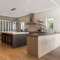 a large kitchen with an island in the middle