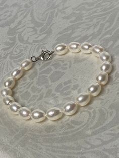 "Beautiful! Sterling Silver 925 & 9mm x 7mm Freshwater Pearl Bracelet.  Measures :  8\"L  Weight: 16.1  grams Stamped: 925 Condition : very good  Thank you for Visiting!" Classic Charm Bracelet With Sterling Silver Clasp, Elegant Sterling Silver Heart Bracelet With Round Beads, Classic Polished Pearl Bracelet As A Gift, Classic Polished Pearl Bracelet As Gift, Classic Polished Pearl Bracelet Gift, Classic Beaded Bracelets With Sterling Silver Clasp As Gift, Classic Sterling Silver Charm Bracelet For Wedding, Classic Sterling Silver Bracelet With 8mm Beads Gift, Elegant Silver Beaded Bracelet With Oval Beads