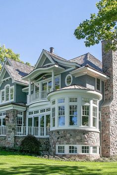 a large house sitting on top of a lush green field