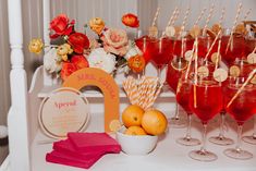 a table topped with lots of glasses filled with drinks