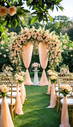 an outdoor ceremony set up with white and peach flowers, gold chairs and pink drapes