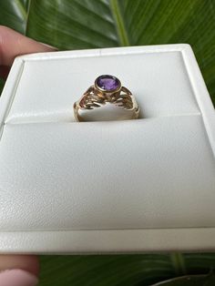 Vintage 9k Gold Natural Amethyst Bezel Hands Ring - Fede Description: Vintage 9k Gold Natural Amethyst Bezel Fede Hands Ring Hallmark: Hallmarked in 1978 at the London Assay Office, UK Stone Size: 3.8 x 3.8 mm natural amethyst (approximately 0.20 carats) Ring Size: UK size H 1/2 (approximately US size 4 3/4, can be resized) Weight: Approximately 2.2 grams This vintage 9k gold ring features a beautiful 3.8 x 3.8 mm natural amethyst, approximately 0.20 carats, set in a bezel setting with an elegan Heirloom 14k Gold Solitaire Amethyst Ring, Heirloom Yellow Gold Amethyst Solitaire Ring, Heirloom Amethyst Ring In Yellow Gold With Bezel Setting, Heirloom Yellow Gold Solitaire Amethyst Ring, Heirloom Amethyst Solitaire Ring In Yellow Gold, Heirloom 14k Gold Round Cut Amethyst Ring, Heirloom Gold Amethyst Ring With Bezel Setting, Heirloom 14k Gold Amethyst Ring With Bezel Setting, Heirloom 14k Gold Purple Birthstone Ring