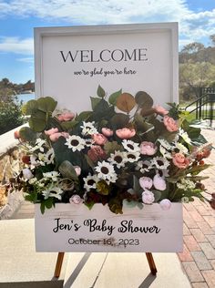 a welcome sign with flowers on it