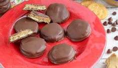 chocolate covered cookies are on a red plate