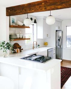 a kitchen with an oven, stove and sink in it's center island next to a window