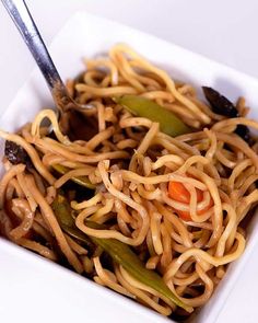 a white bowl filled with noodles and vegetables