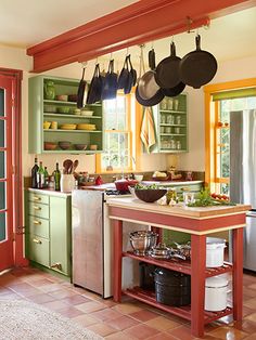 a kitchen with pots and pans hanging from the ceiling