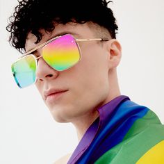 a man wearing sunglasses with rainbow colors on his shirt