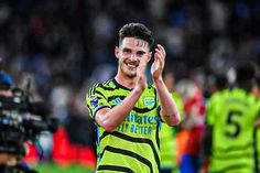 a soccer player is applauding the crowd