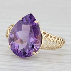 Gemstone Information: - Natural Amethyst - Carats - 7.50ct Cut - Pear Brilliant Color - Purple Metal: 14k Yellow Gold Weight: 4.3 Grams  Stamps: 14k Face Height: 16 mm  Rise Above Finger: 7.7 mm Band / Shank Width: 2.7 mm This ring is a size 8, but it can be resized down 2 sizes for a $20 fee or up 3 sizes for a $30 fee. If you would like your ring resized, please select the appropriate fee from the listing below in order to pay the sizing fee: https://www.etsy.com/listing/781388346/ring-sizing-service-fee Each piece is thoroughly examined and refinished as needed by our professional jewelers, graded by our in-house GIA (Gemological Institute of America) Graduate Gemologist, and inspected for quality before being carefully packaged and promptly shipped. [SKU: B36144] Teardrop Ring, Rise Above, Brilliant Colors, Solitaire Ring, Pear, Jewelry Rings, Amethyst, Yellow Gold, Band