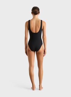 The Vida One Piece in Black is a flattering plunge V neck swimsuit, crafted from our Sculpteur® fabric, which supports and shapes the bust. Vida features wide, comfortable shoulder straps and flattering side panels which help define the silhouette. Vida features regular bottom coverage is suitable for large busts up to cup size DD. Fabric sustainably made in Italy.Garment sustainably made in Australia. Black One-piece Bodysuit For Diving, Black One-piece Swimwear For Pool, Black One-piece Bodysuit For Sunbathing, Black One-piece Diving Bodysuit, Black One-piece Swimwear With Lined Body For Beach, Dd Cup, Deep Plunge, Luxury Swimwear, Black One Piece