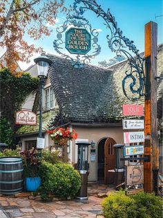 an old fashioned building with many signs on it