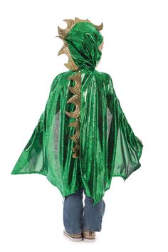 a child wearing a green cape with gold dragon decorations on it's head and shoulders