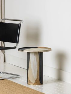 two chairs and a table in front of a mirror on the floor next to each other