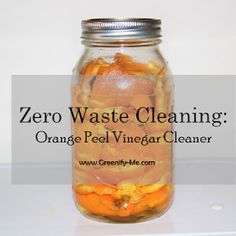 a glass jar filled with orange peel vinegar cleaner