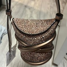 Authentic Alexander Mcqueen Metallic Calfskin Crystal Mini Curve Bucket In Bag Rose Gold This Chic Crossbody Features A Crystalized Exterior In Rose Gold, A Crisscross Strap Accent, And An Adjustable Shoulder Strap. The Flap Top Opens To A Leather Burgundy Base Length:3.25 In Height:4.25 In Width:3.00 In Drop:19.50 In Metallic Clutch Bag, Alexander Mcqueen Bag, Metallic Clutch, Rose Gold Color, Bucket Bag, Alexander Mcqueen, Calf Skin, Gold Color, Alexander