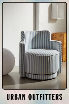 a blue and white striped chair sitting in front of a wall with the words urban outfitters on it