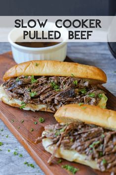 slow cooker pulled beef sandwiches on a cutting board