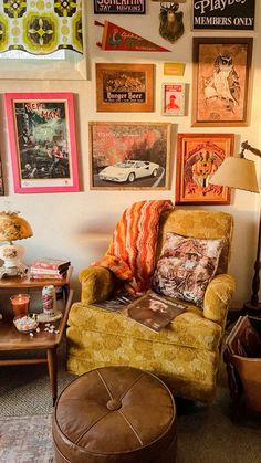 a living room filled with furniture and pictures on the wall