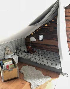 a room with a bed, bookshelf and stuffed animals on the floor in it