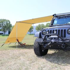 a jeep with a tent attached to it's roof